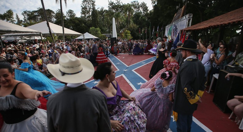 People stand in traditional outfits between dances at the annual Festa Confederada, or Confederate Festival, on April 24, 2016.