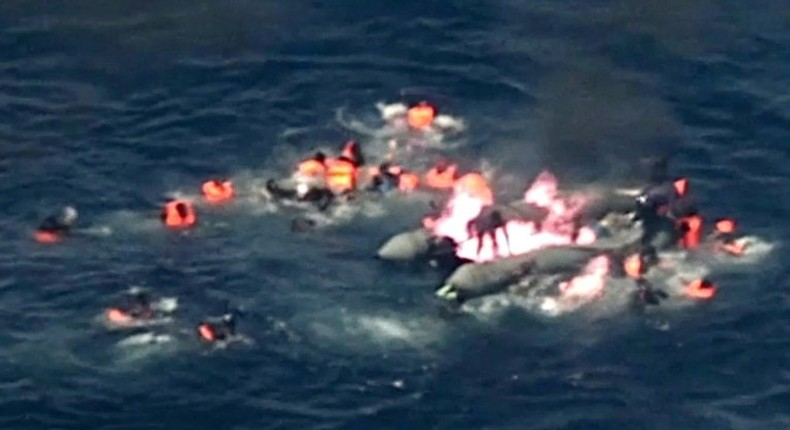 Image grab from handout video footage by the Portuguese air force shows migrants in the water waiting for rescue after their boat caught fire