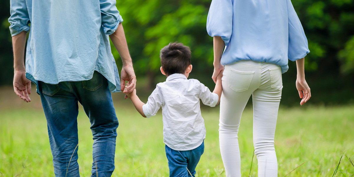 young parents walking with kid