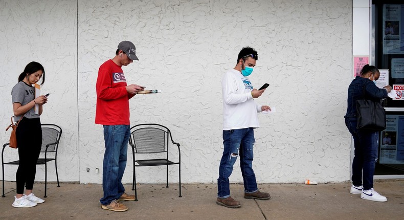 FILE PHOTO: People who lost their jobs wait in line to file for unemployment following an outbreak of the coronavirus disease (COVID-19), at an Arkansas Workforce Center in Fayetteville, Arkansas, U.S. April 6, 2020. REUTERS/Nick Oxford