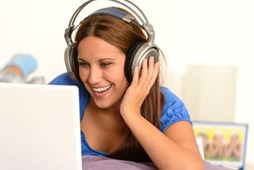 activity,adolescence,bed,bedroom,caucasian,cheerful,computer,enjoying,entertainment,fun,funny,girl,happy,headphones,indoor,internet,laptop,laughing,leisure,lifestyle,listening,lying,movie,music,relaxing,studying,surfing,teenager,using,watching,woman,young