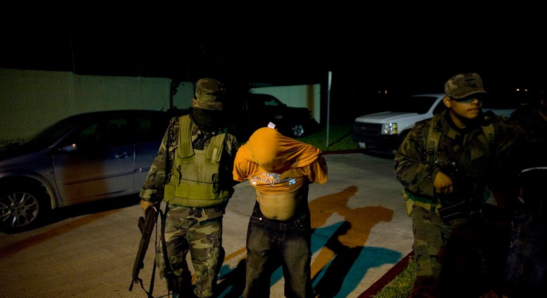 Soldiers arrest an alleged member of a kidnapping gang in Reynosa, Mexico, March 17, 2009.