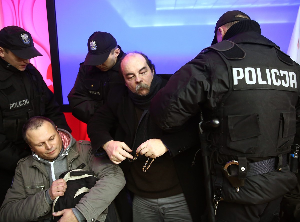 Policja wyprowadza protestujących, którzy 20 listopada w trakcie manifestacji przed PKW wtargnęli do siedziby Państwowej Komisji Wyborczej i zajęli salę konferencyjną