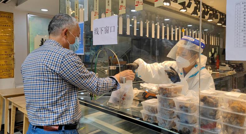 A man buys food in Shanghai, China. Shanghai said it would lift some COVID-19 lockdown restrictions starting on June 1, 2022.