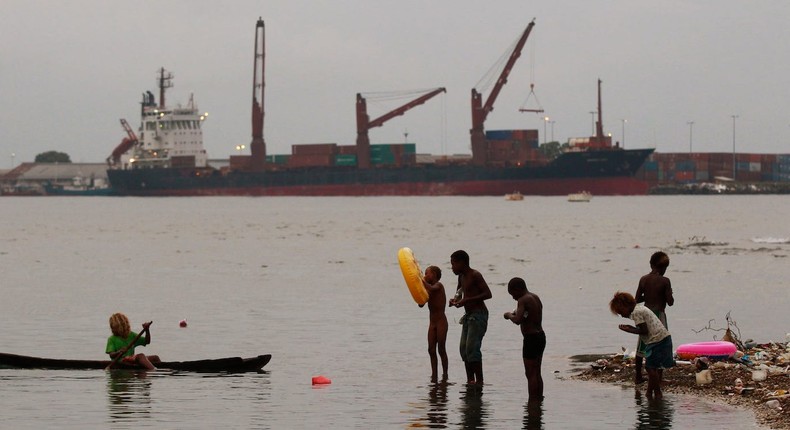 Children fish at a polluted beach in central Honiara September 14, 2012.