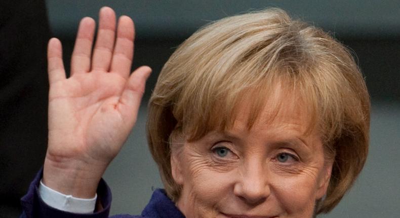 German Chancellor Angela Merkel waves to another Member of the Bundestag before leaving the German Federal Parliament in Berlin, Friday, May 7, 2010.