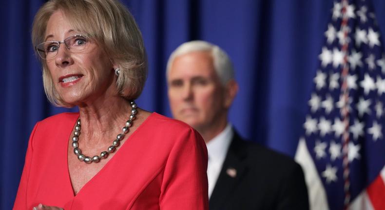 US Secretary of Education Betsy DeVos speaks as Vice President Mike Pence listens during a White House Coronavirus Task Force press briefing at the US Department of Education July 8, 2020 in Washington, DC.