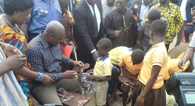 President Mahama distributing sandals to students