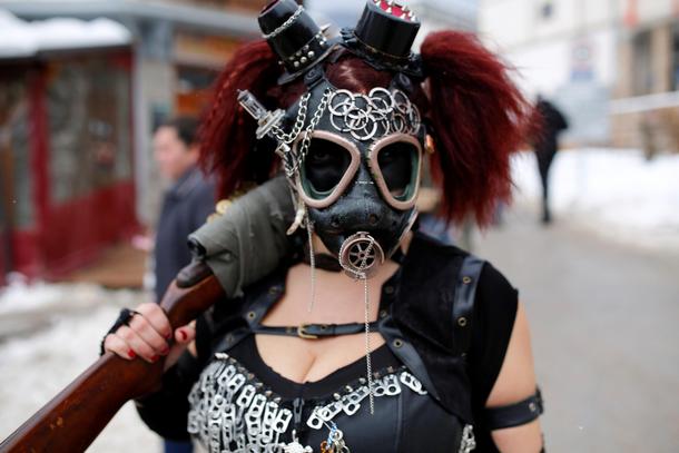A reveler participates in a parade on the streets during a carnival to mark the annual Orthodox St. 