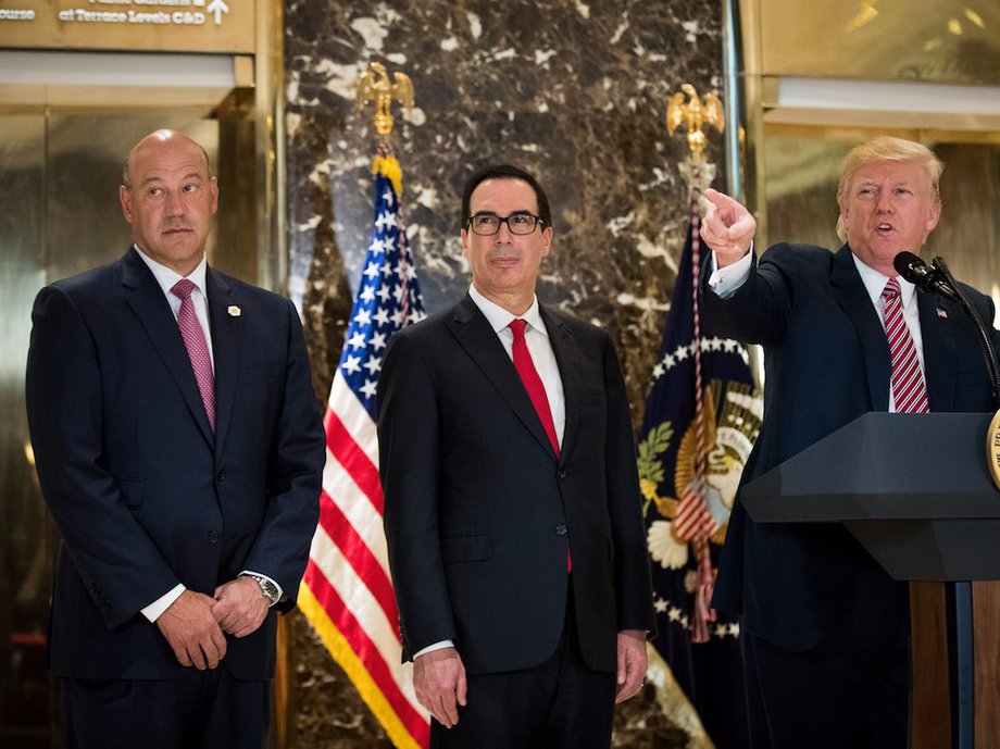 Top White House economic adviser Gary Cohn and Treasury Secretary Steven Mnuchin look on as Trump answers reporters' questions about his reaction to the white supremacist rally in Charlottesville last month.