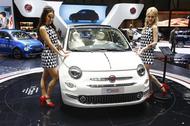 Models pose next to a new Fiat 560 car during the 87th International Motor Show at Palexpo in Geneva