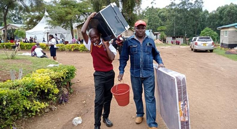 A form one student arrives at Kerugoya Boys Secondary School in Kirinyaga county accompanied by his parent. Photo credit: George Munene | Nation Media Group