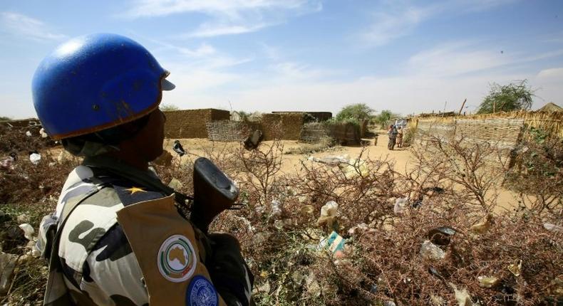 A member of the peacekeeper troops stands guard at a UN refugee camp in the city of Nyala, in South Darfur, on January 9, 2017