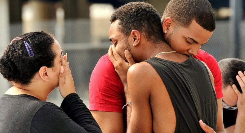 Mourners comfort themselves following Orlando shooting which left 50 people dead.