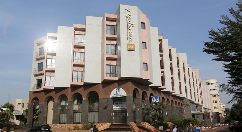 People drive motorcycles past the Radisson Blu hotel in Bamako, Mali, November 22, 2015. REUTERS/Joe Penney