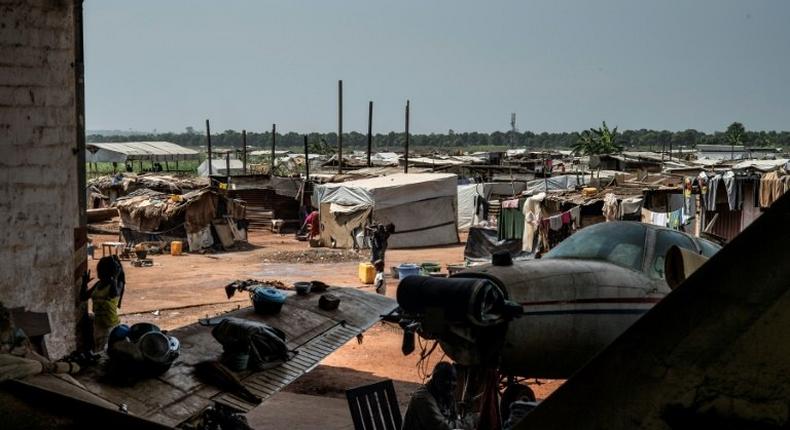 People go about their daily lives at a refugee and displaced persons camp at the M'Poko airport in Bangui on December 7, 2015