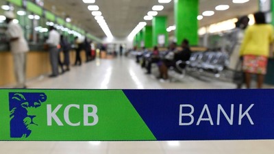 Customers are served at the Kenya Commercial Bank (KCB) in Nairobi on January 24, 2018. (Photo by SIMON MAINA/AFP via Getty Images)