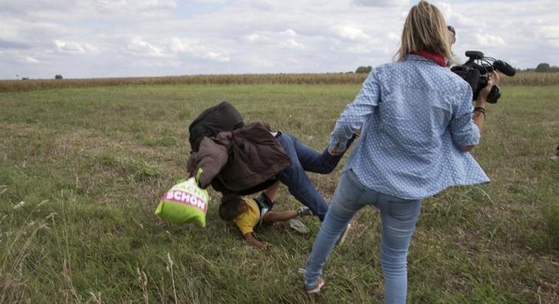 Hungary charges camerawoman accused of tripping fleeing migrants