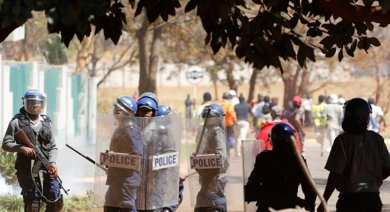 Police officers look on during a protest by opposition party supporters in Harare, Zimbabwe, August 26,2016. 