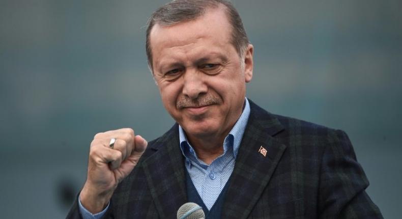 Turkish President Recep Tayyip Erdogan gestures as he delivers a speech on April 8, 2017 during a campaign rally for the yes vote in a constitutional referendum in Istanbul