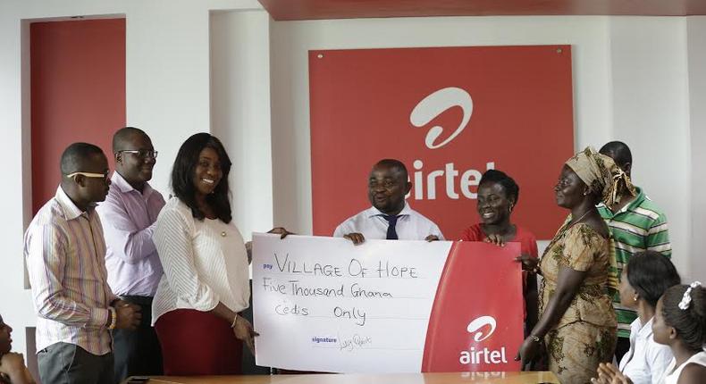 Hilary Denise Arko-Dadzie (3rd from left), from Airtel Ghana making the presentation to Mr. Kwaku Sarkodie, representative of Village of Hope Orphanage