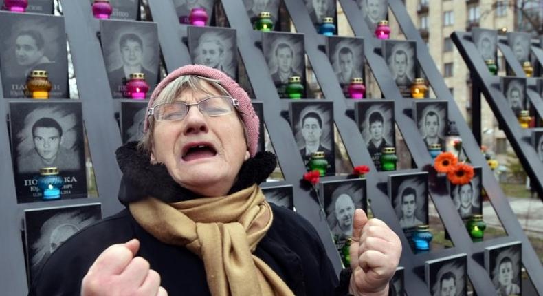 A woman cries at a memorial in Kiev for activists who lost their lives in February 2014, on November 21, 2016