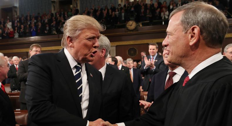 President Donald Trump shakes hands with Supreme Court Chief Justice John Roberts as he arrives on Capitol Hill in Washington on Feb. 28, 2017, for his address to a joint session of Congress.