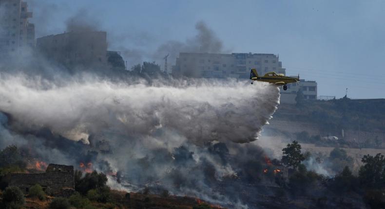 A plane extinguishes a fire in the Jerusalem area on July 18, 2019