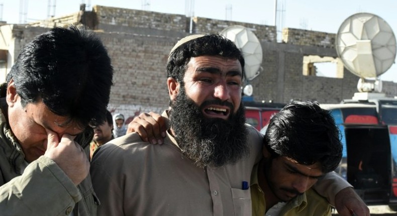 Pakistani relatives mourn the loss of family members in Quetta on October 25, 2016 after an attack on the Balochistan Police College