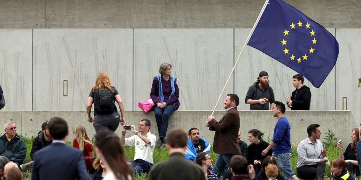 A man waves a European Union flag outside the Scottish Parliament at Holyrood in Edinburgh.