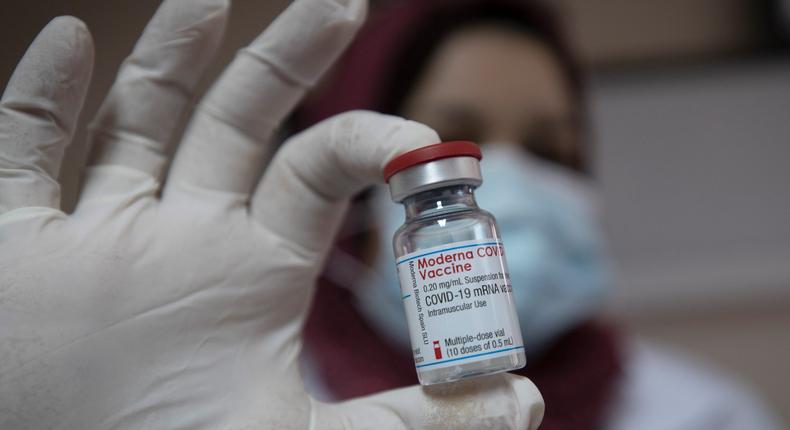 A Palestinian medic displays a vial of the Moderna COVID-19 vaccine.
