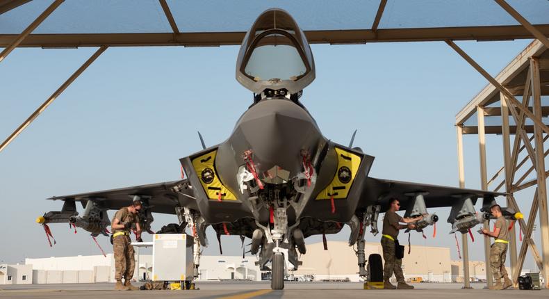 A three-man weapons load team from the 380th Expeditionary Maintenance Group, loads an F-35A Lightning II with a full external loadout at Al Dhafra Air Base, United Arab Emirates, May 2019.