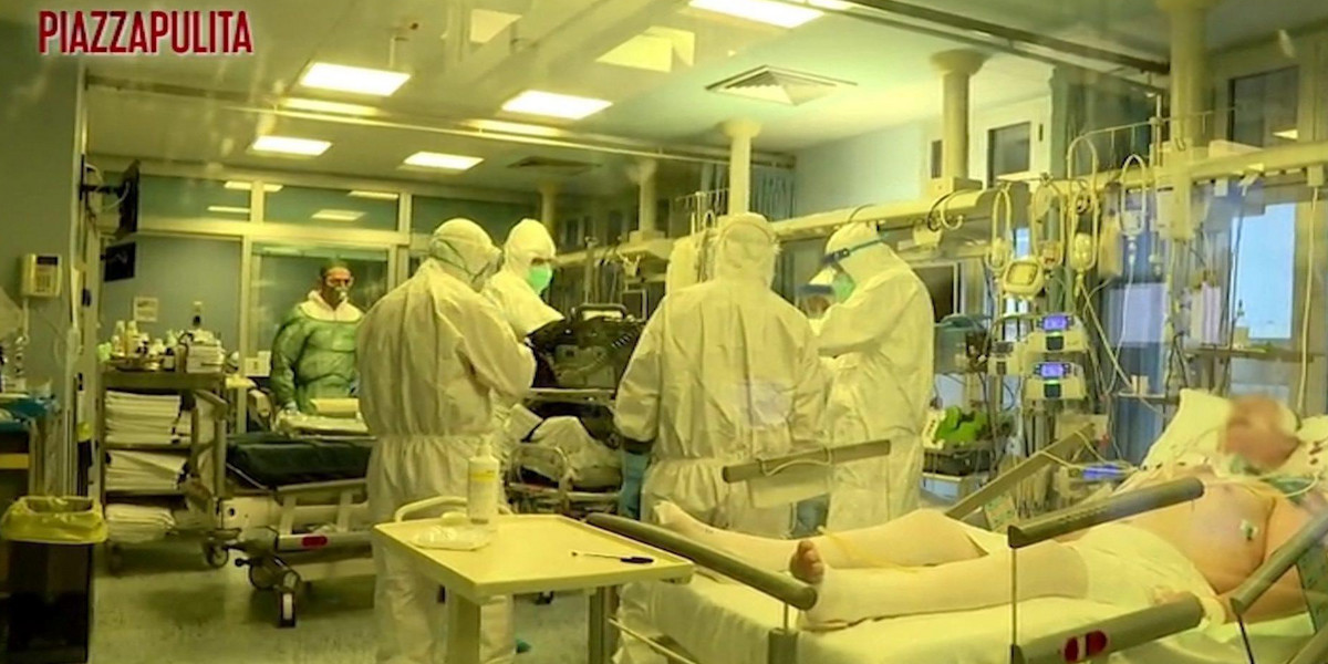 Medical staff in protective suits treat coronavirus patients in an intensive care unit at the Cremona hospital in northern Italy
