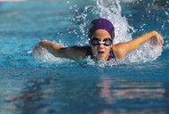 A young girl swimming in a pool