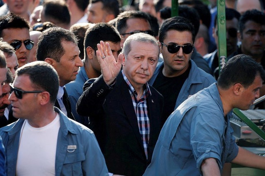 Turkish President Recep Tayyip Erdogan waves to the crowd following a funeral service for a victim of the thwarted coup.