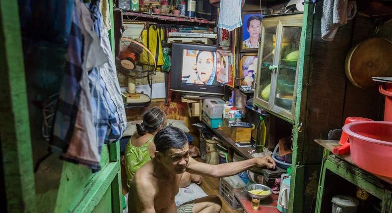 Kha Tu Ngoc watches television next to her husband Pham Huy Duc in n Ho Chi Minh City in Vietnam.THANH NGUYEN/AFP/Getty Images