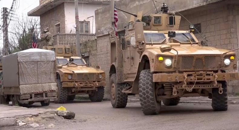 US armored vehicles at the scene of a suicide attack in the northern Syrian town of Manbij, where a suicide bomber killed 19 people including four Americans on January 16, 2019