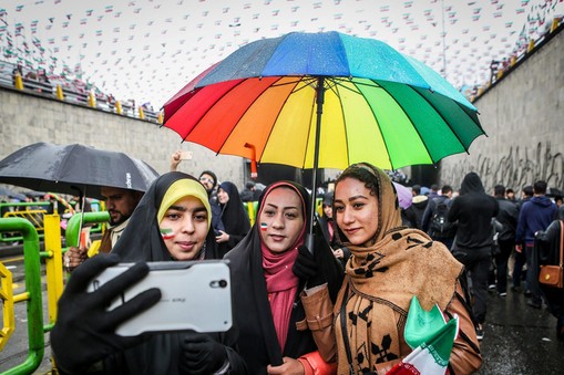 An Iranian woman take selfies during a ceremony to mark the 40th anniversary of the Islamic Revoluti