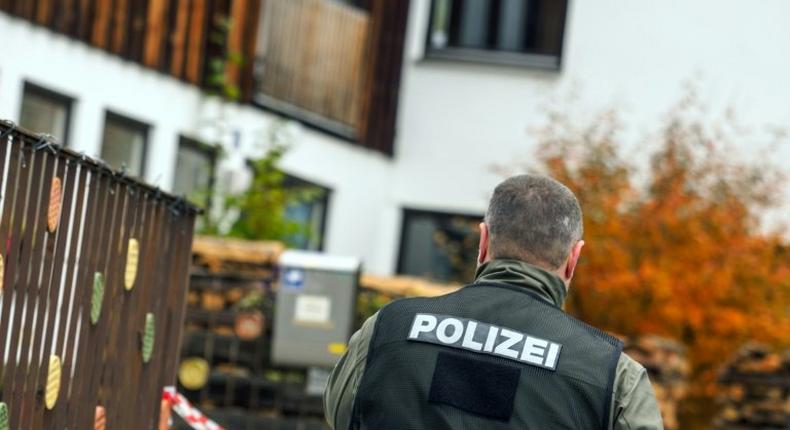 A policeman is pictured on October 19, 2016 in Georgensgmuend, southern Germany, in front of a house of a member of the so-called Reichsbuerger movement