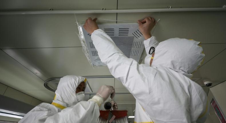 Medical staff seal a vent in what used to be an isolation ward for patients infected by the COVID-19 coronavirus at a hospital in Wuhan, China