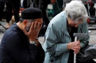 A Jewish woman named Renee Rachel Black and a Muslim man named Sadiq Patel react next to floral trib