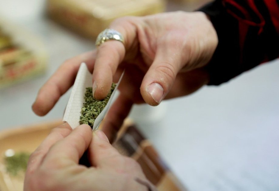 A participant practices rolling a joint at the Cannabis Carnivalus 4/20 event in Seattle.