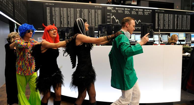 Stock traders in carnival costumes dance over the trading floor of the German stock exchange in Frankfurt, February 24, 2009.