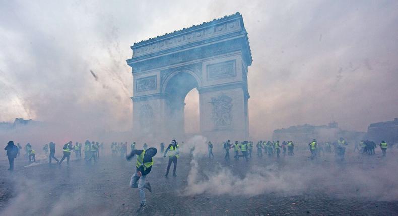 Teargas surrounds protesters as they clash with riot police during a 'Yellow Vest' demonstration near the Arc de Triomphe in Paris on Saturday.