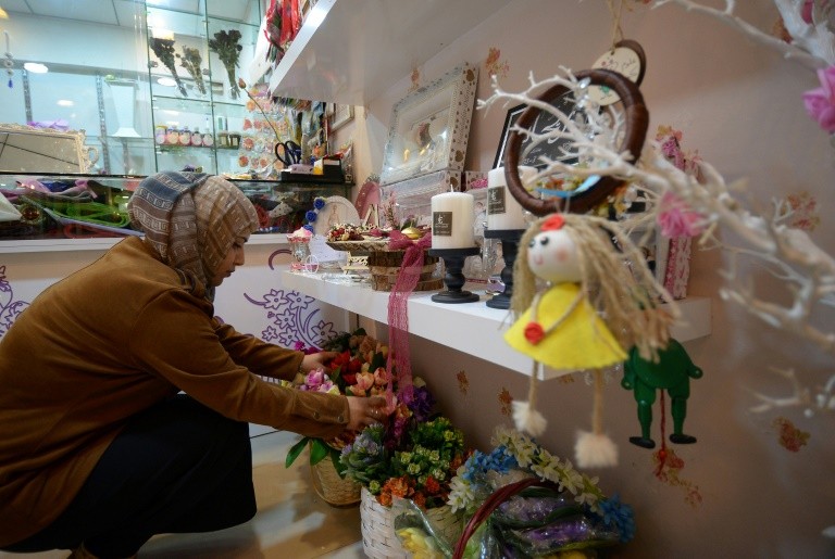 An Iraqi woman works in her decorative accessories shop in Iraq's northern city of Mosul on December 20, 2018