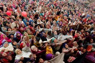 Kashmiri Muslims react upon seeing a relic believed to be a hair from the beard of Prophet Mohammed, being displayed on the Friday following the festival of Eid-e-Milad-ul-Nabi, the birthday anniversary of the prophet, at the Hazratbal shrine in Srinagar