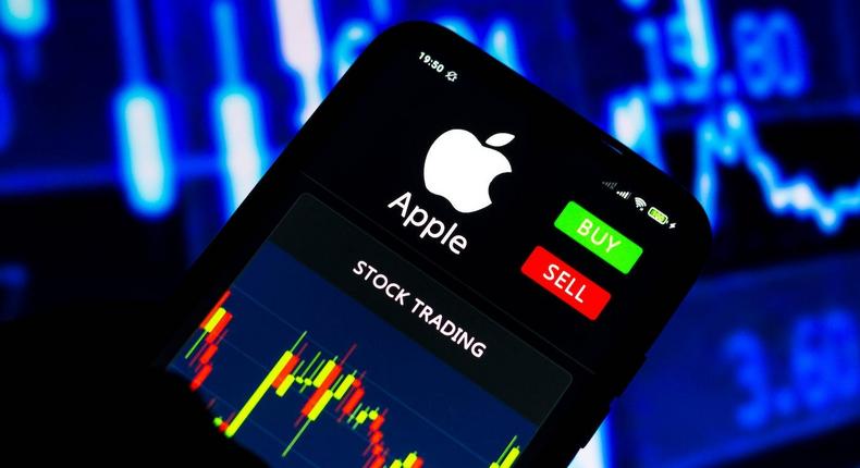 Stock trading graph of Apple seen on a smartphone screen.