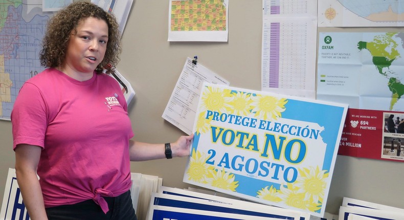 Jessica Porter, communications chair for the Shawnee County, Kansas, Democratic Party, discusses a sign in Spanish urging voters to oppose a proposed amendment to the Kansas Constitution to allow legislators to further restrict or ban abortion, Friday, July 15, 2022, in Topeka, Kansas.