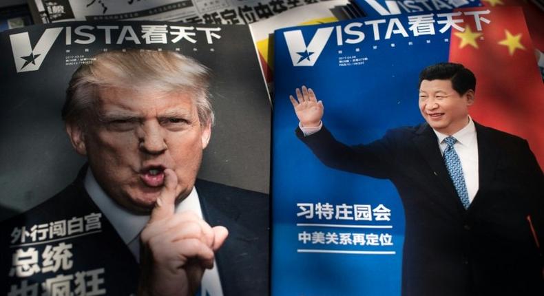 Magazines featuring front page pictures of US President Donald Trump and China's President Xi Jinping are displayed at a news stand in Beijing