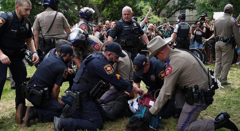A person is detained by police as pro-Palestinian students protest the Israel-Hamas war on the campus of the University of Texas at Austin.SUZANNE CORDEIRO/AFP via Getty Images